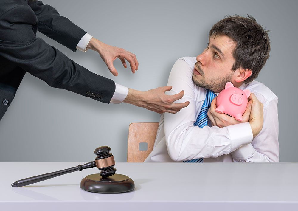 Man clutching piggy bank